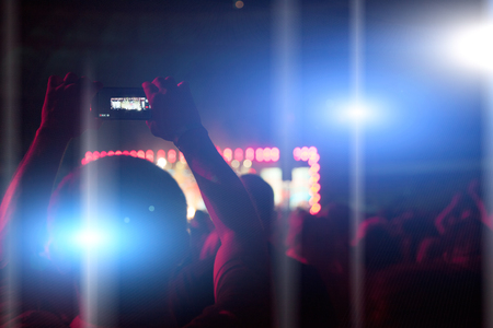 Silhouettes of people and musicians on big concert stageの写真素材