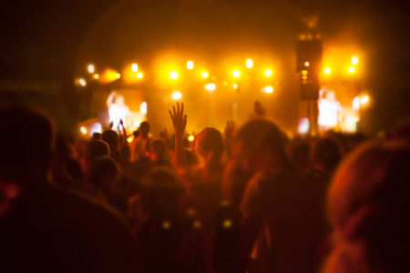 Silhouettes of people and musicians on big concert stageの写真素材