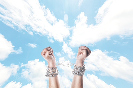 Two hands in chains on a white backgroundの写真素材