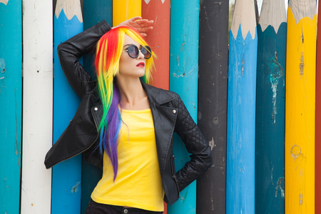 beautiful woman wearing color wig and sunglassesの写真素材
