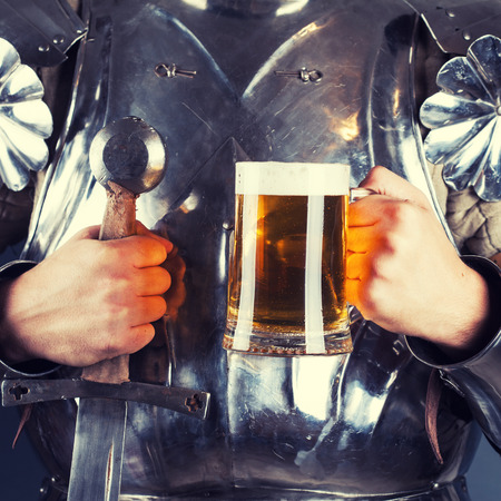 knight wearing armor and holding mug of beer and two-handed sword