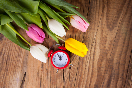 bouquet of purple, yellow and white tulips on a wooden backgroundの写真素材