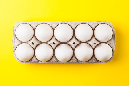 white eggs on a yellow background close up image