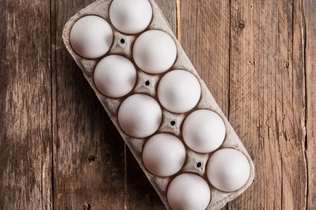 white eggs on a wooden background close up imageの写真素材