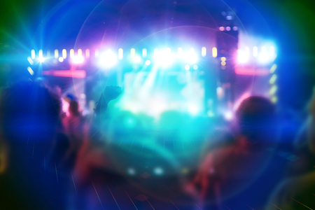 Silhouettes of people and musicians on big concert stage