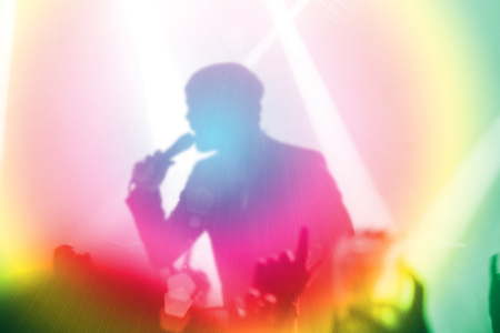 Silhouettes of people and musicians in big concert stageの写真素材