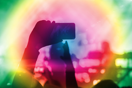 Silhouettes of people and musicians in big concert stageの写真素材