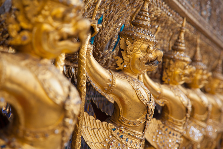 Garuda Wat Phra Kaew Bangkok Thailand - A line of ornate golden demons at the Grand Palace in Bangkok, Thailandの写真素材