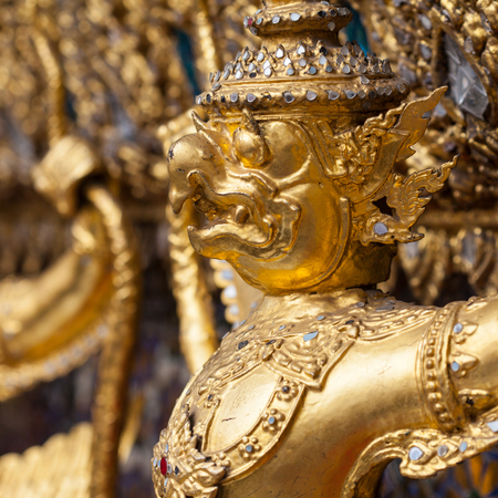 Garuda Wat Phra Kaew Bangkok Thailand - A line of ornate golden demons at the Grand Palace in Bangkok, Thailandの写真素材