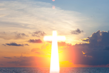 Glowing cross on beautiful sky backgroundの写真素材