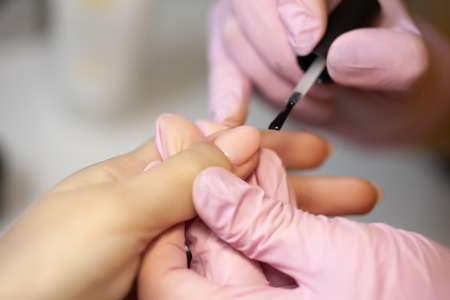 Master of manicure makes nail extensions gel in the beauty salonの写真素材