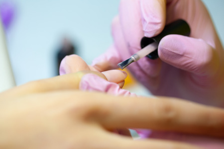 Master of manicure makes nail extensions gel in the beauty salonの写真素材