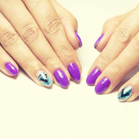Female hands in manicure salon with a beautiful manicureの写真素材