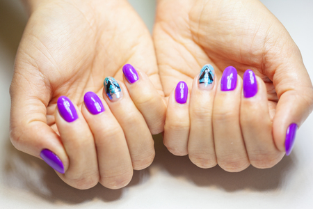 Female hands in manicure salon with a beautiful manicureの写真素材