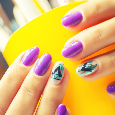 Female hands in manicure salon with a beautiful manicureの写真素材