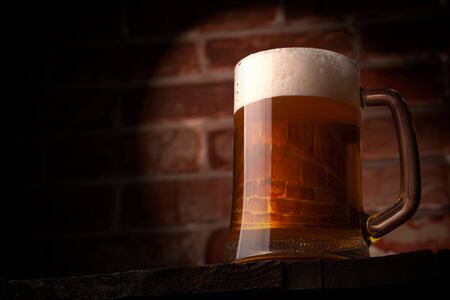 Mug of a beer on the red brick wall backgroundの写真素材