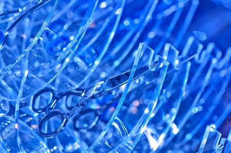 scissors on the blue abstract background for making hairdressingの写真素材