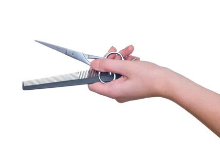 scissors and comb in the hand の写真素材