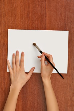 woman paints a picture with a brushの写真素材
