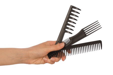 hairdresser holds the black tools for haircutの写真素材