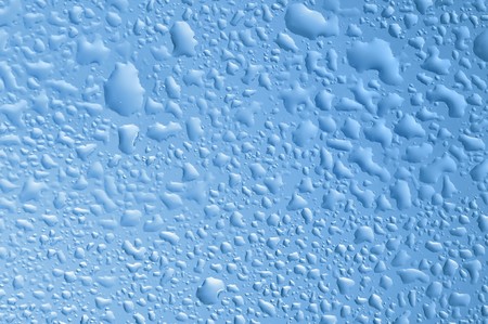 blue water bubbles on the window for backgroundの写真素材