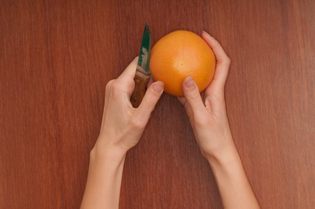 Slice of a fresh Sicilian orange in the handの写真素材