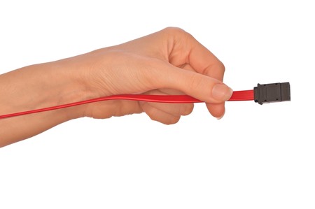 woman holding power HDD cord in the handの写真素材