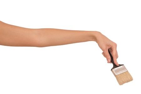 The woman draws the brush on the wallの写真素材