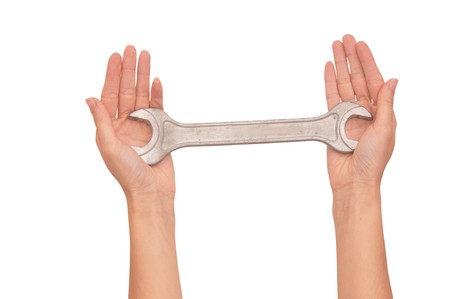 woman holding chrome vanadium spanner in the handsの写真素材