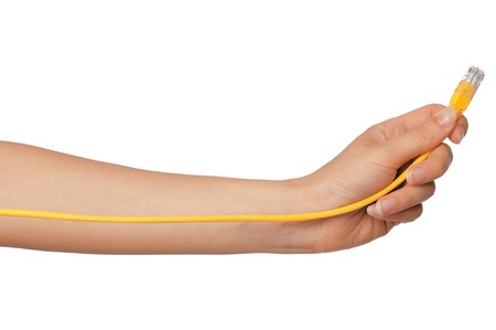 woman holding yellow LAN cord in the handの写真素材