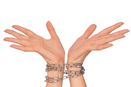 Woman bounded metal chains as a symbol of punishmentの写真素材