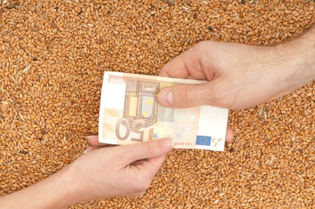 The businesswoman pays delivery of wheat by euroの写真素材