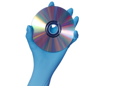 inspector in blue gloves holds in a hand confidential audio and video about hacker programs and virusesの写真素材