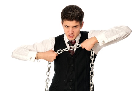 businessman breaking the chain by hands for liberation as a symbol of work captivityの写真素材