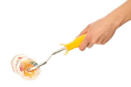worker painting a wall with colored paint roller to redecorate her flat