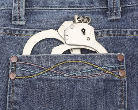 handcuffs in jeans pocketの写真素材