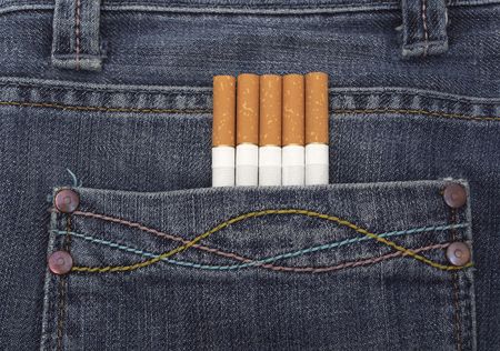close up of a blue jeans pocket with cigarettes coming out of itの写真素材