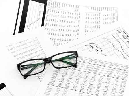 Accounting. black glasses lies on stack document