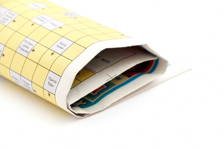 rolled up newspaper isolated on white backgroundの写真素材