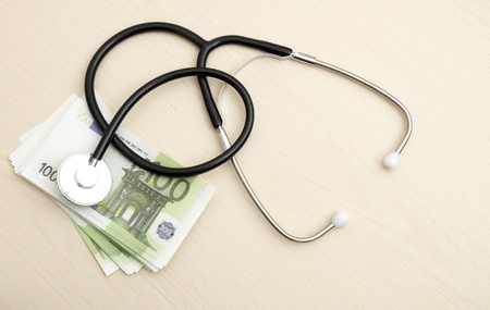 Many Euro bank notes with a stethoscope. Health costs.の写真素材