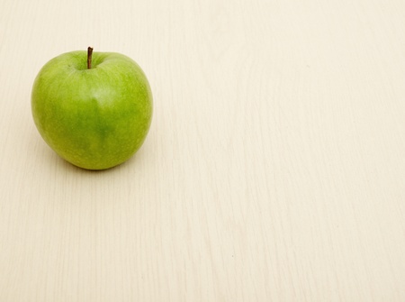 Green apple on wooden table example of healthy eatingの写真素材