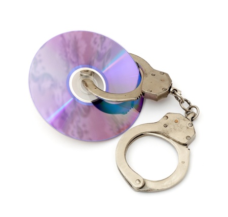 Cd with handcuffs isolated on white backgroundの写真素材