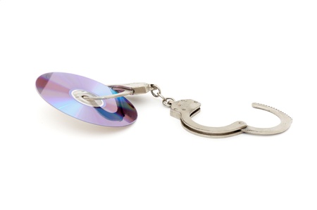 Cd with handcuffs isolated on white backgroundの写真素材