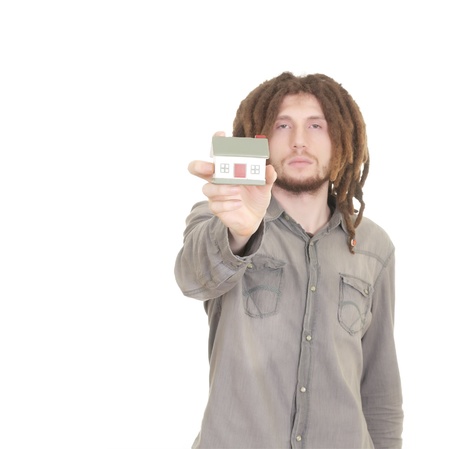 man holding a small house in his hands isolated on whiteの写真素材