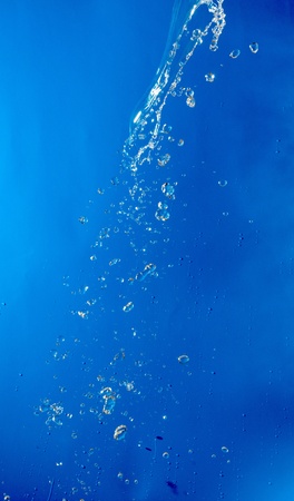 beautiful water splash on blue gradient backgroundの写真素材