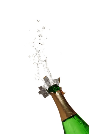 Bottle of champagne with splashes over white backgroundの写真素材