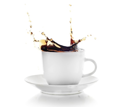 Coffee splash in white cup isolated on whiteの写真素材