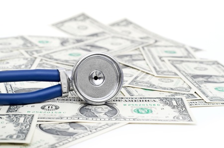 blue Stethoscope and dollars illustrating expensive healthcareの写真素材