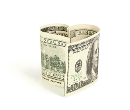 Dollar in form of heart isolated on a white backgroundの写真素材