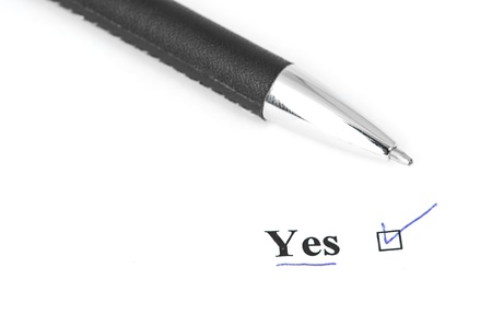 yes and pen isolated on a white backgroundの写真素材